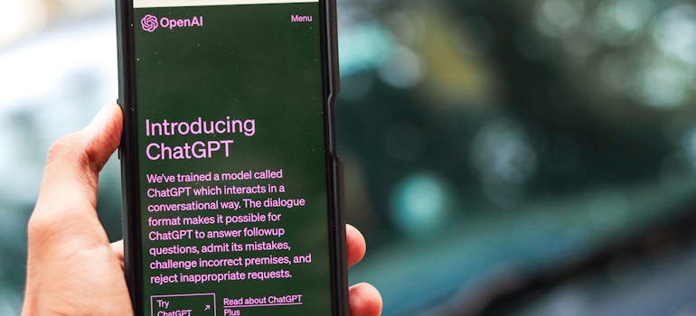 a hand holding a smartphone with ChatGPT on the screen