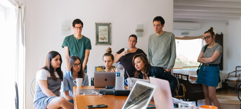 a group of people looking at a computer screen