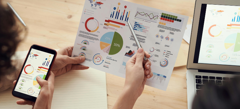 Charts and graphs showing what is online reputation management on a smartphone, paper, and laptop.