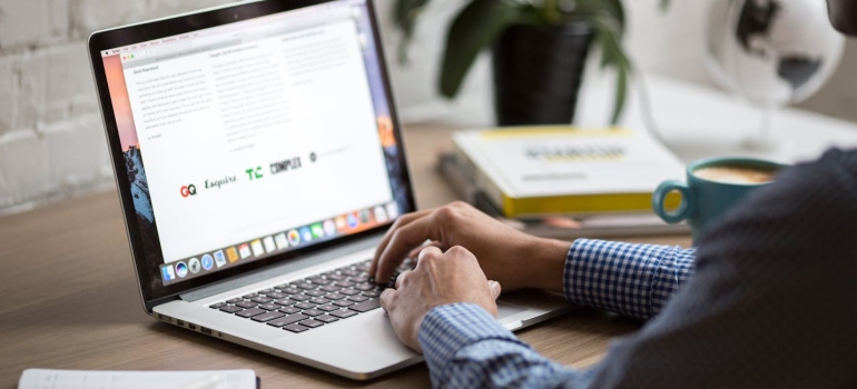 A person using their computer to do research and learn about aesthetic clinic patient loyalty