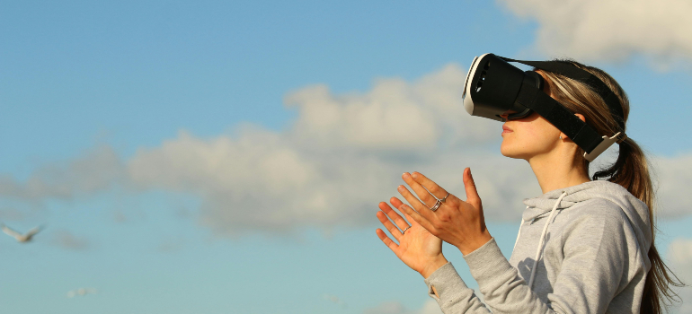 Person using a VR headset, illustrating the future of digital health care and how to market a medical clinic with innovative technology.