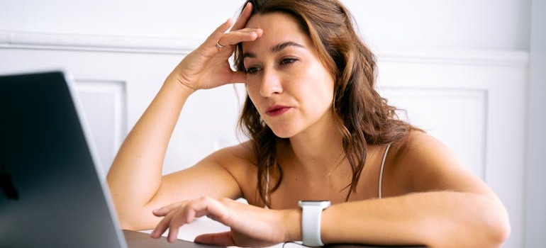 A frustrated person using a laptop
