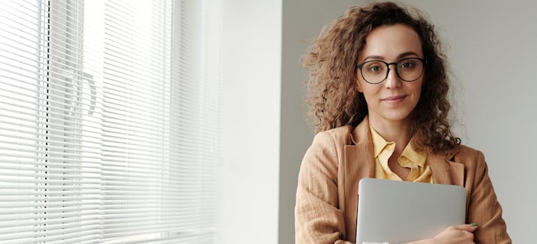 A satisfied person holding a laptop after discovering the role of organic traffic in driving admissions to rehab centers