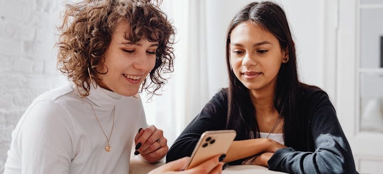 Two friends looking at a phone