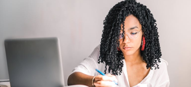 A person reading about the power of everyday language in rehab marketing and taking notes