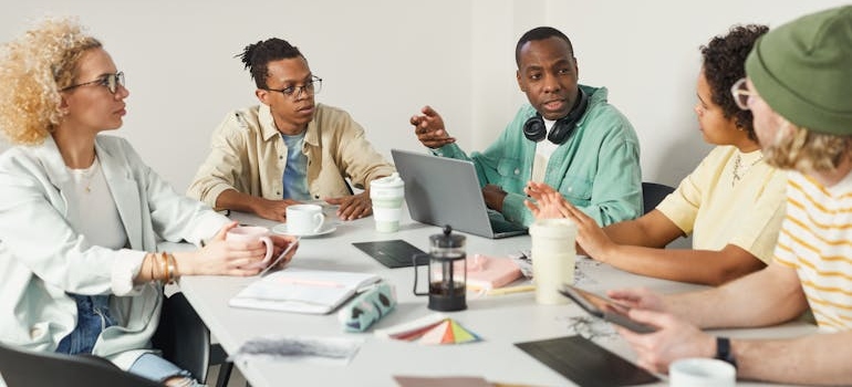 A digital marketing team discussing and comparing email marketing vs. social media marketing for mental health clinics