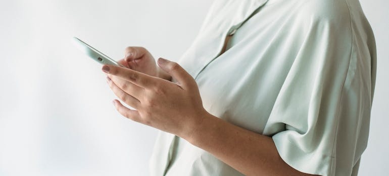 A person using their smartphone to do research online and learn how to reach adolescents struggling with mental health