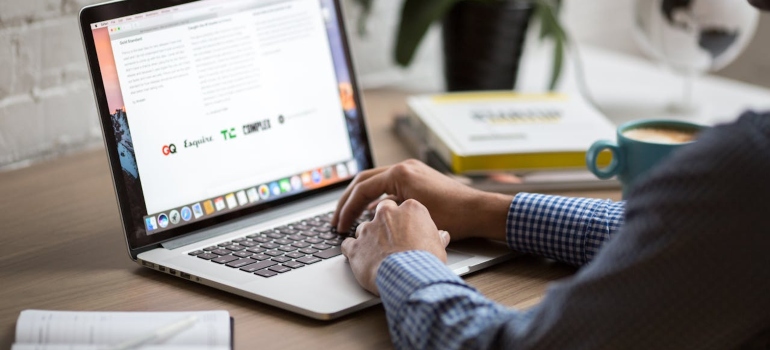 Person using a laptop to turn one blog into a month of social content