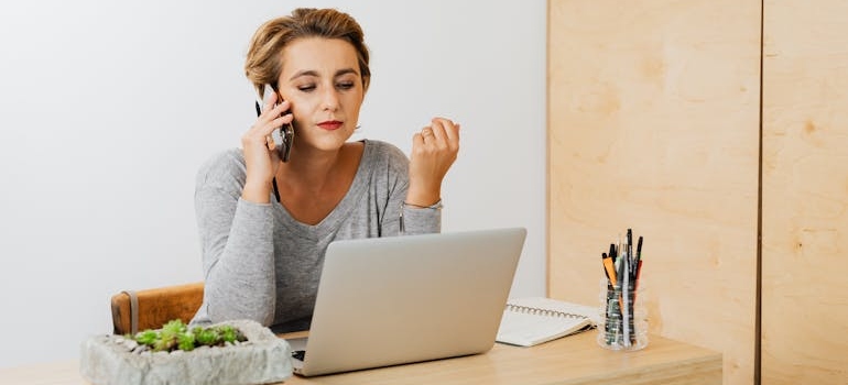 A person making a phone call after reading a service page, which is one of the most important pages on your therapy website