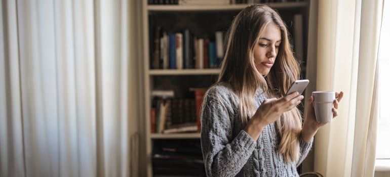 A person reading a message from a company that uses WhatsApp & SMS marketing for aesthetic clinics effectively