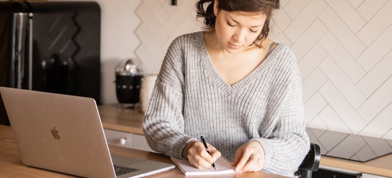 A parent taking notes after calling a mental health center that knows how to build a back-to-school campaign