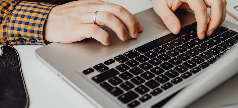 A person using a laptop to look for detox centers