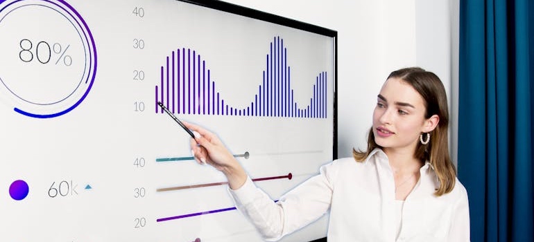 A person showing data during a meeting about retargeting vs remarketing