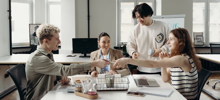 A team of digital marketing experts during a meeting on retargeting vs. remarketing