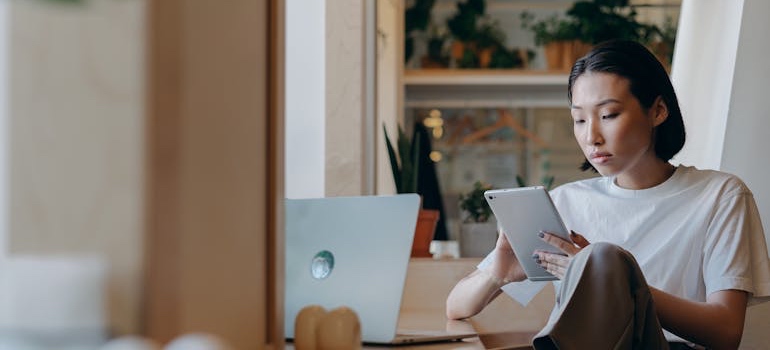 A person sitting a using a tablet to search online