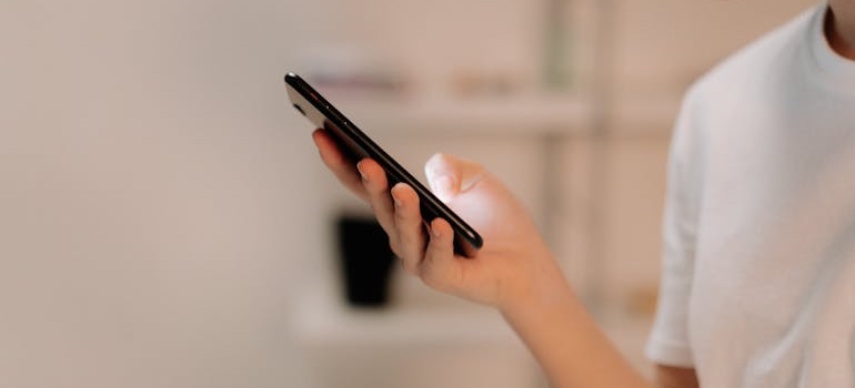 A person using a smartphone to look for aesthetic clinics