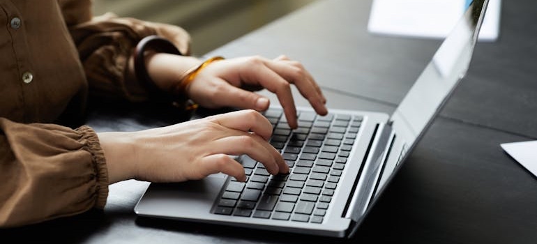 A person using a laptop to create digital content
