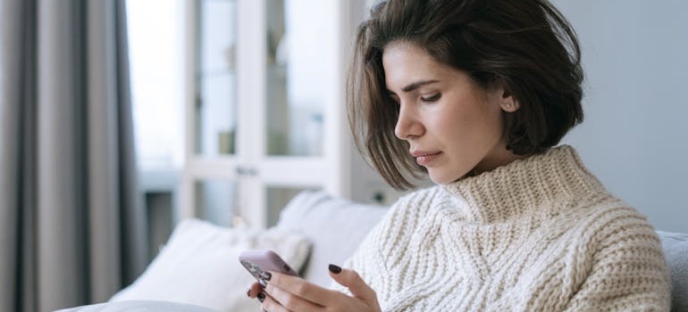 Person using a smartphone to search for rehab centers online