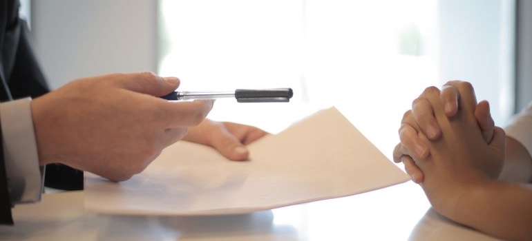 A person signing a consent form at a desk