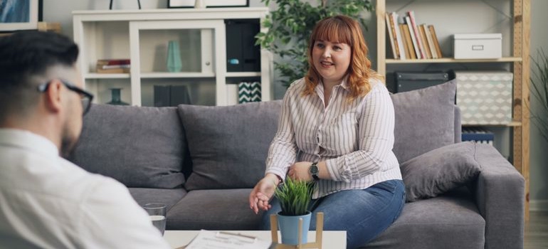 A person talking with a counselor while sitting on a couch
