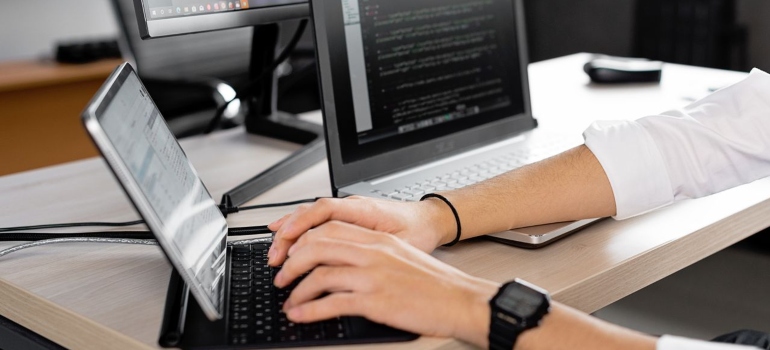 a man typing something on his laptop